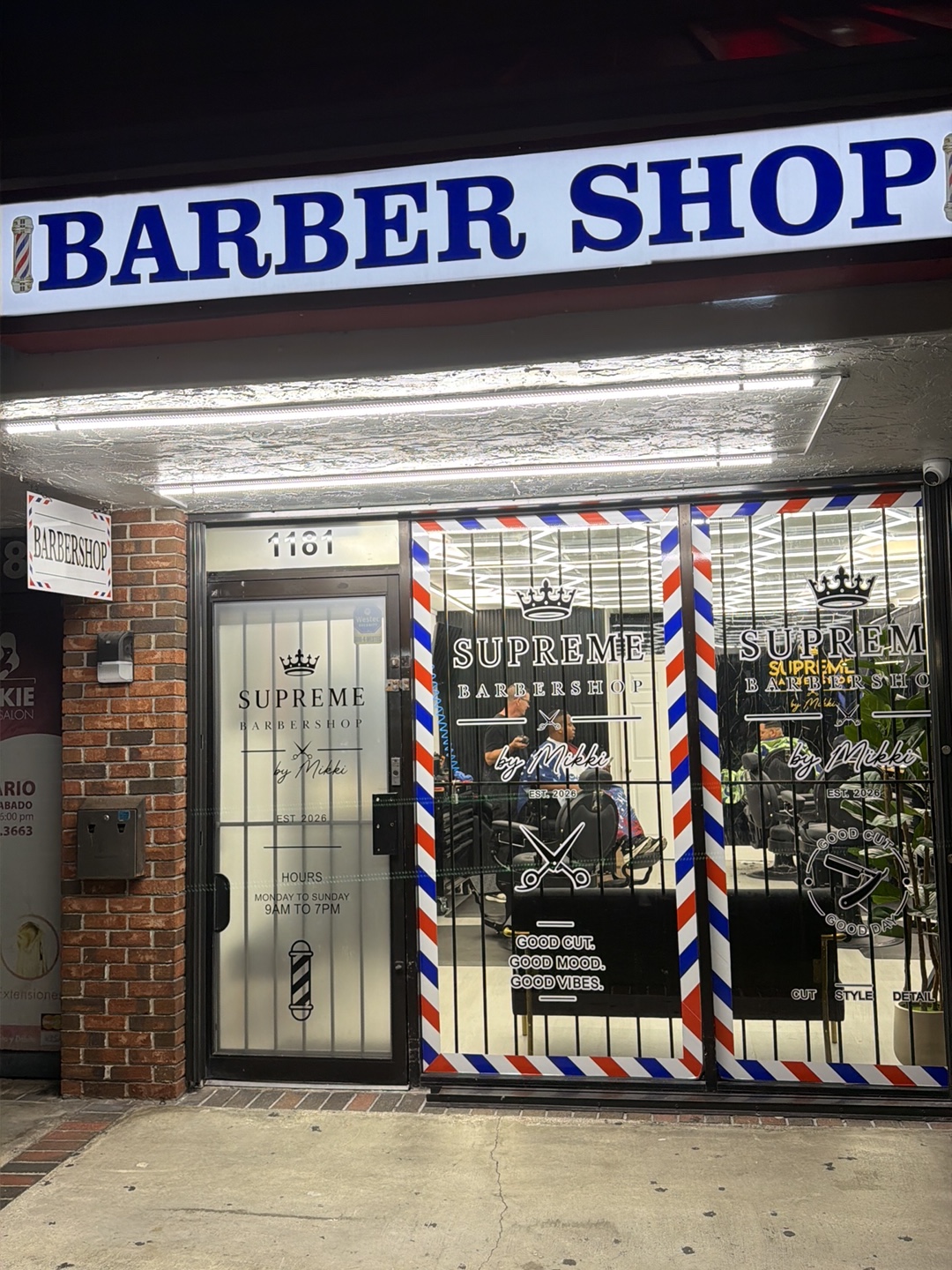 Supreme Barbershop by Mikki storefront with barber pole and signage